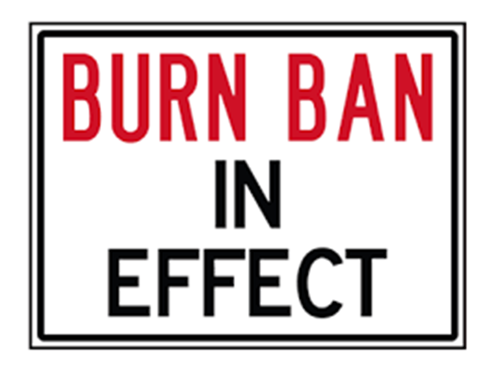 A red and white sign stating "burn ban in effect" enclosed within a black border.